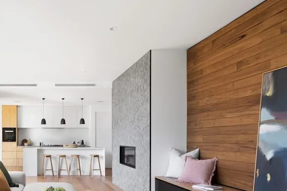 Built-in counter, cabinetry and bar seating in an open-plan kitchen.